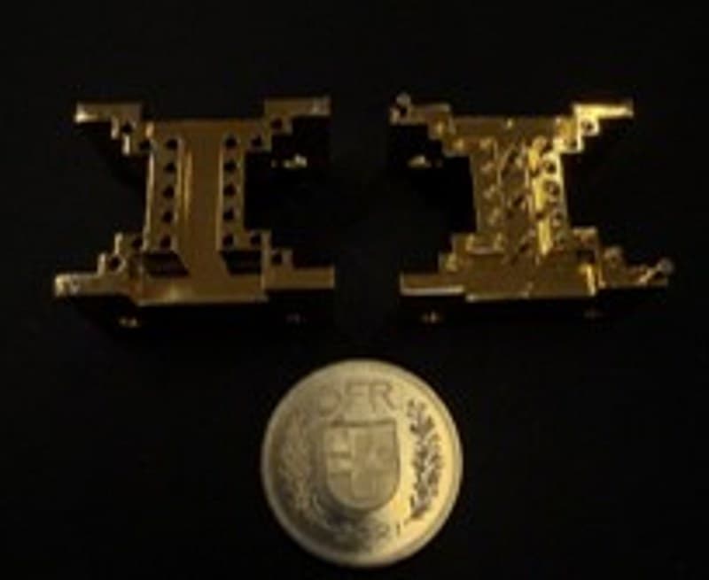 Narrow Ku-band Locally Resonant Metamaterial bandpass filter, gold-plated, next to a Swiss franc coin
